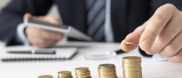 Businessman counting his profits with a calculator